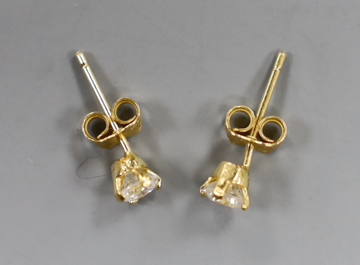 A pair of 18kt and solitaire diamond set ear studs, gross weight 1.2 grams.